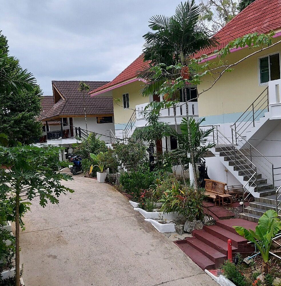 Real garden pathway between resort buildings